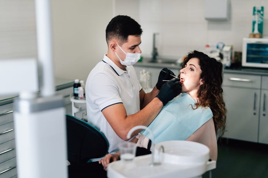 dentist-checking-patient-office