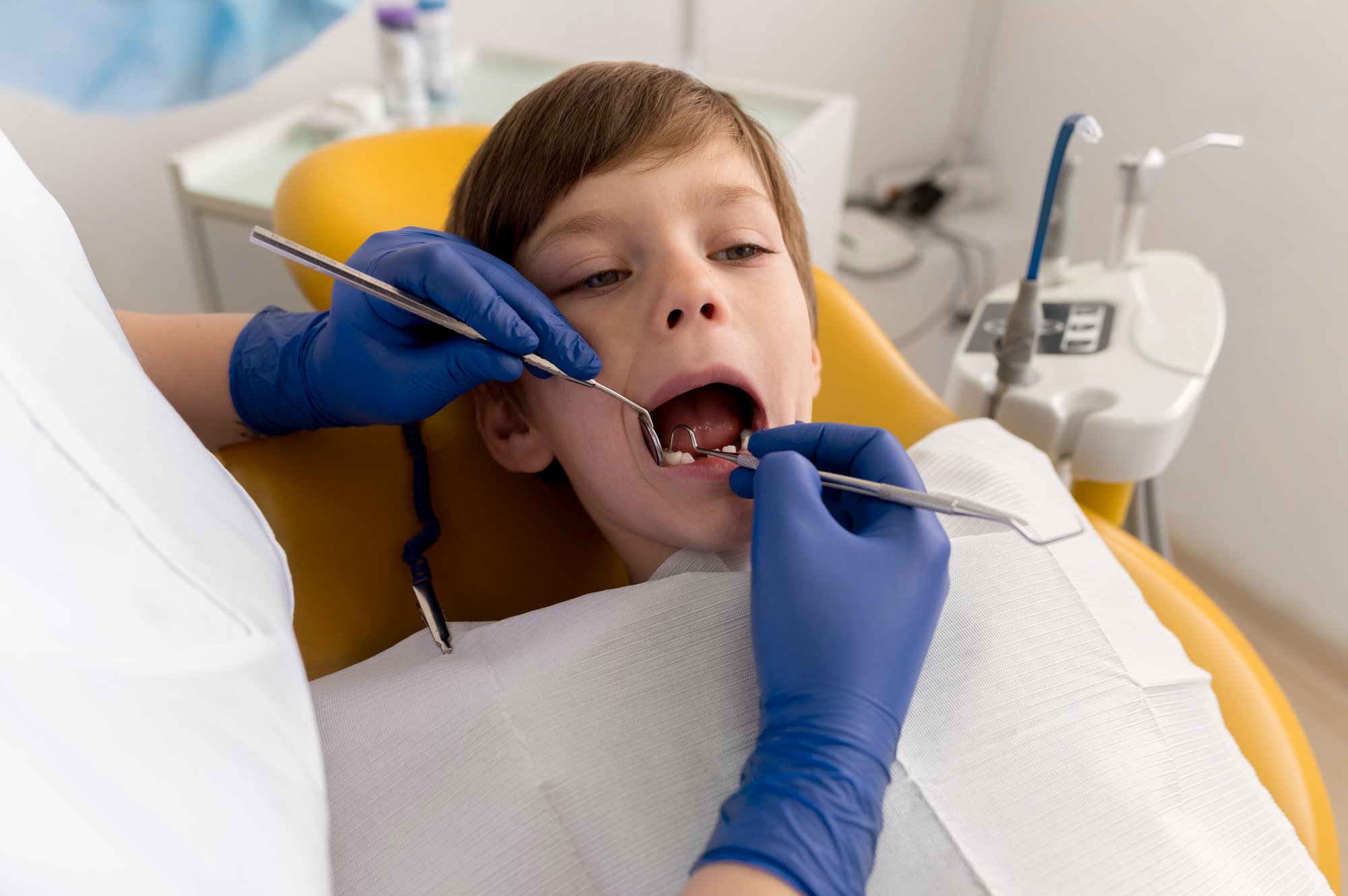 dentist-cleaning-child-s-teeth dentist-cleaning-child-s-teeth