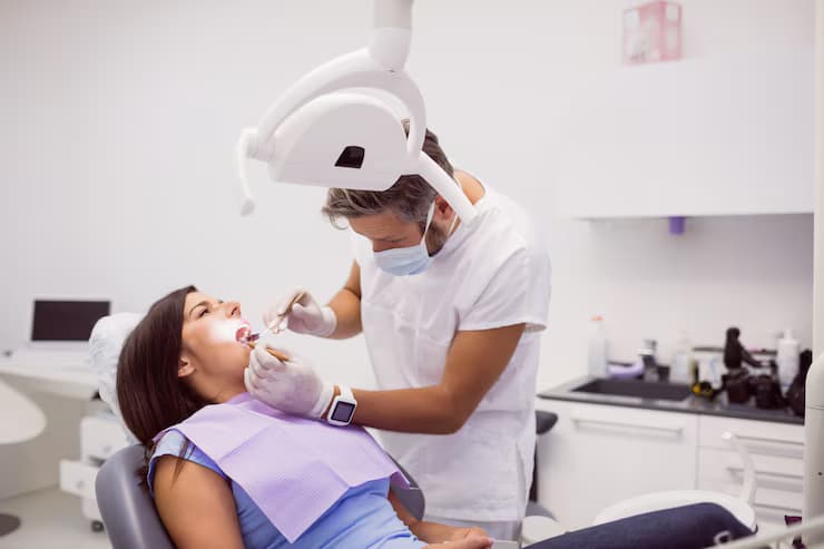 dentist-examining-female-patient-teeth_107420-65302-2
