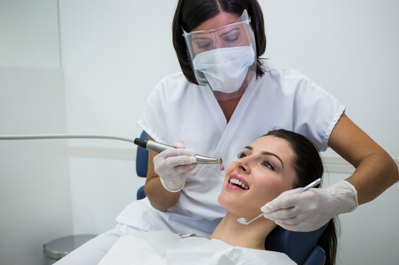 dentist-examining-female-patient-with-tools-1