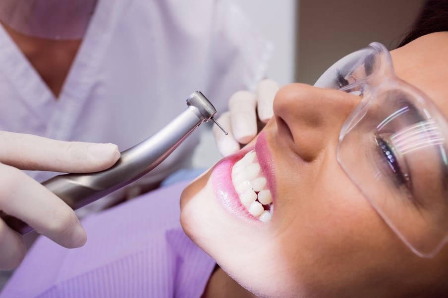 dentist-examining-female-patient