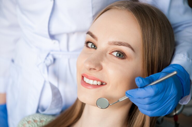 dentist-examining-patient-s-teeth-dental-clinic_104603-3147