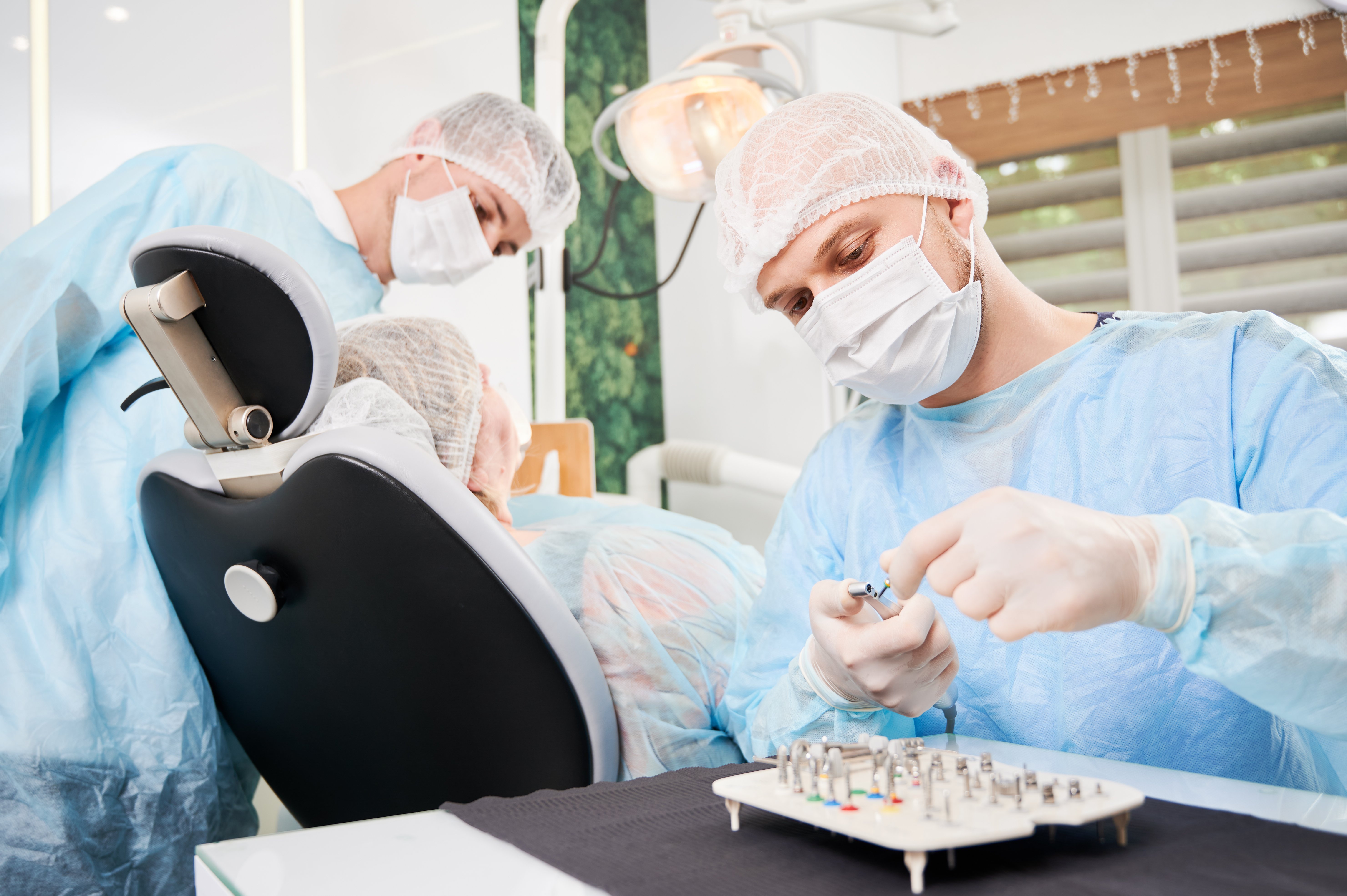 dentist-his-assistant-working-with-patient-dentist-chair-dentist-office-1