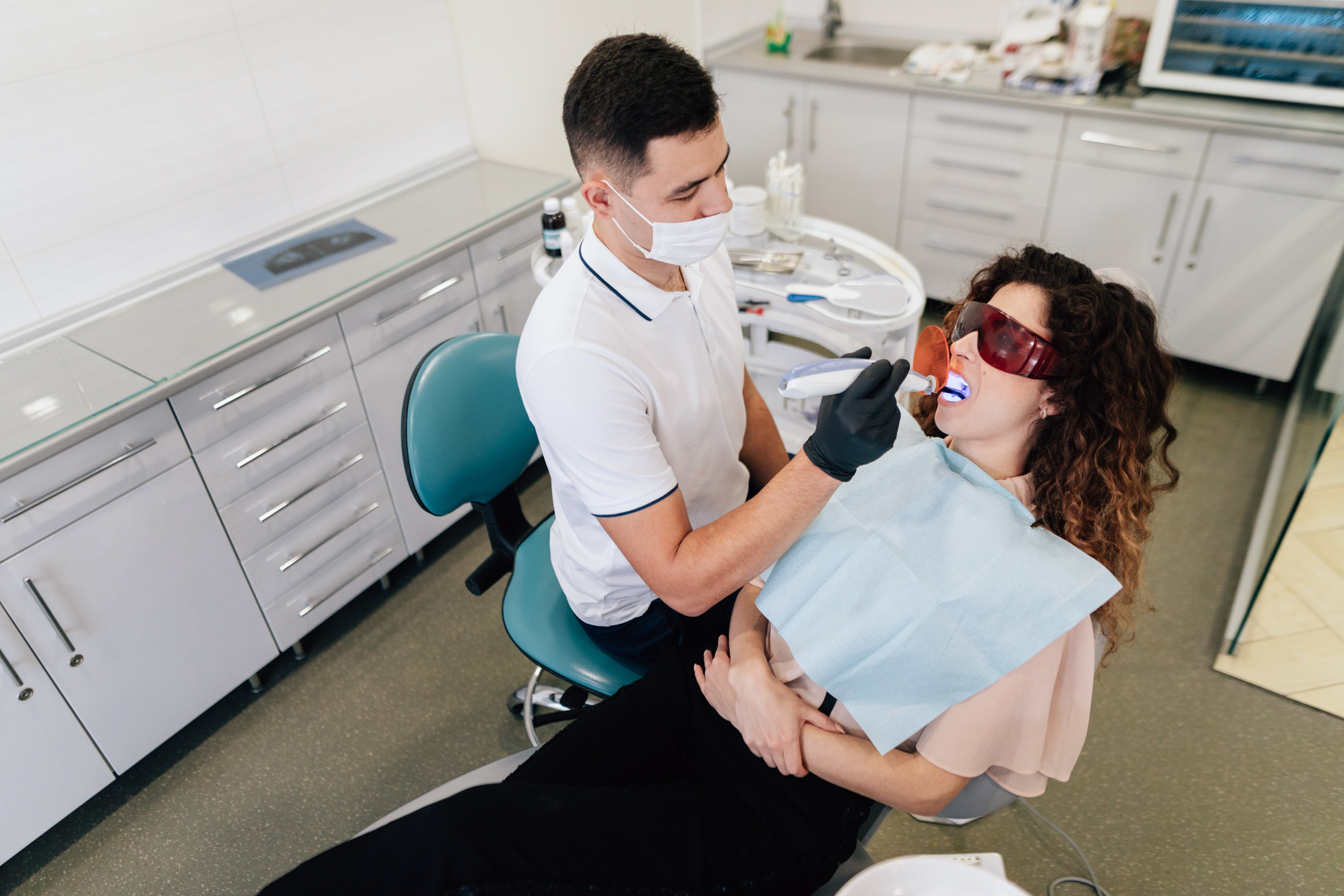 dentist-performing-whitening-patient