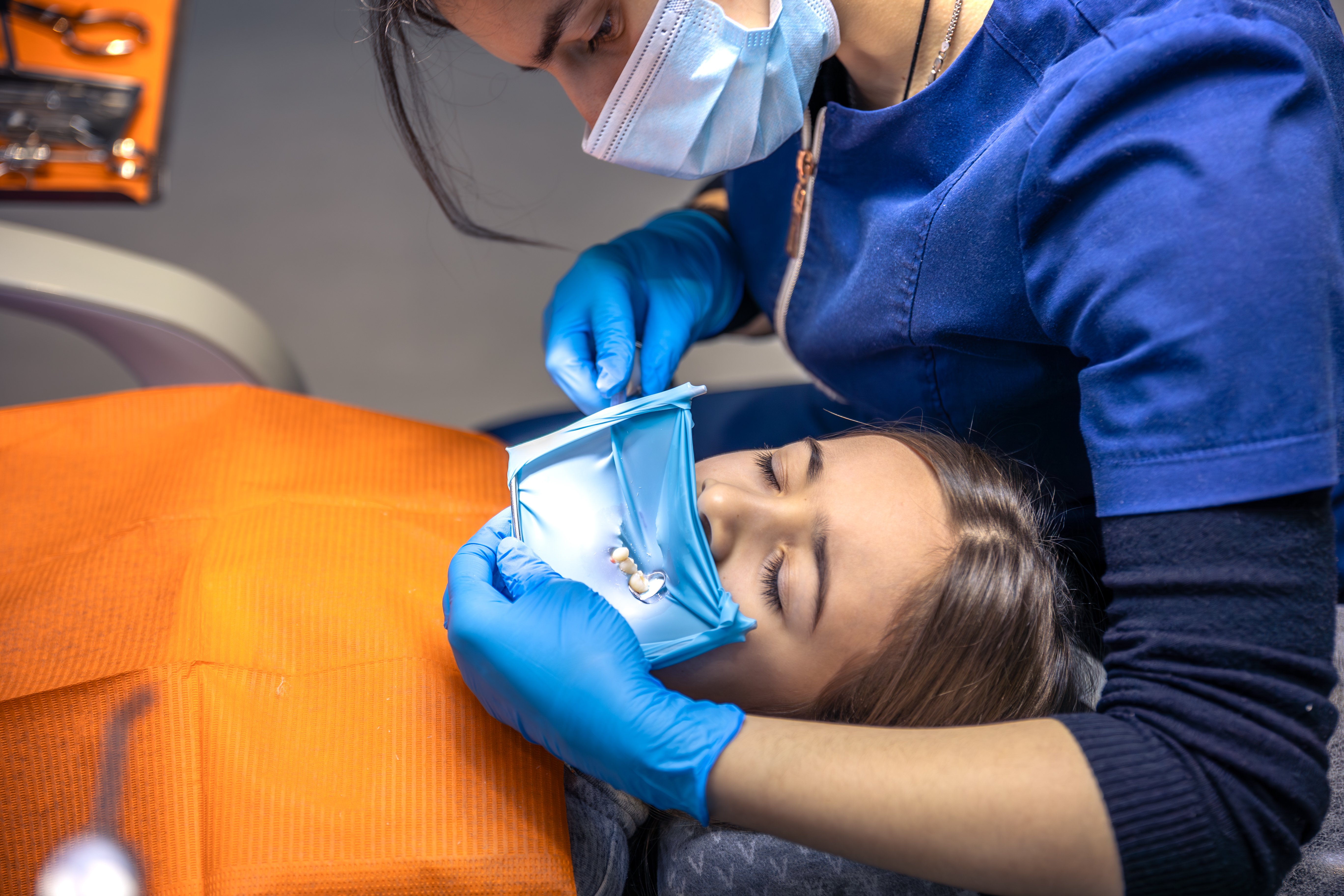 dentist-treats-childs-tooth-using-rubber-dam-closeup-tooth-treatment (1)