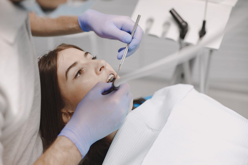 female-patient-with-braces-has-dental-examination-dentist-office-woman-wearing-white-clothes (1)