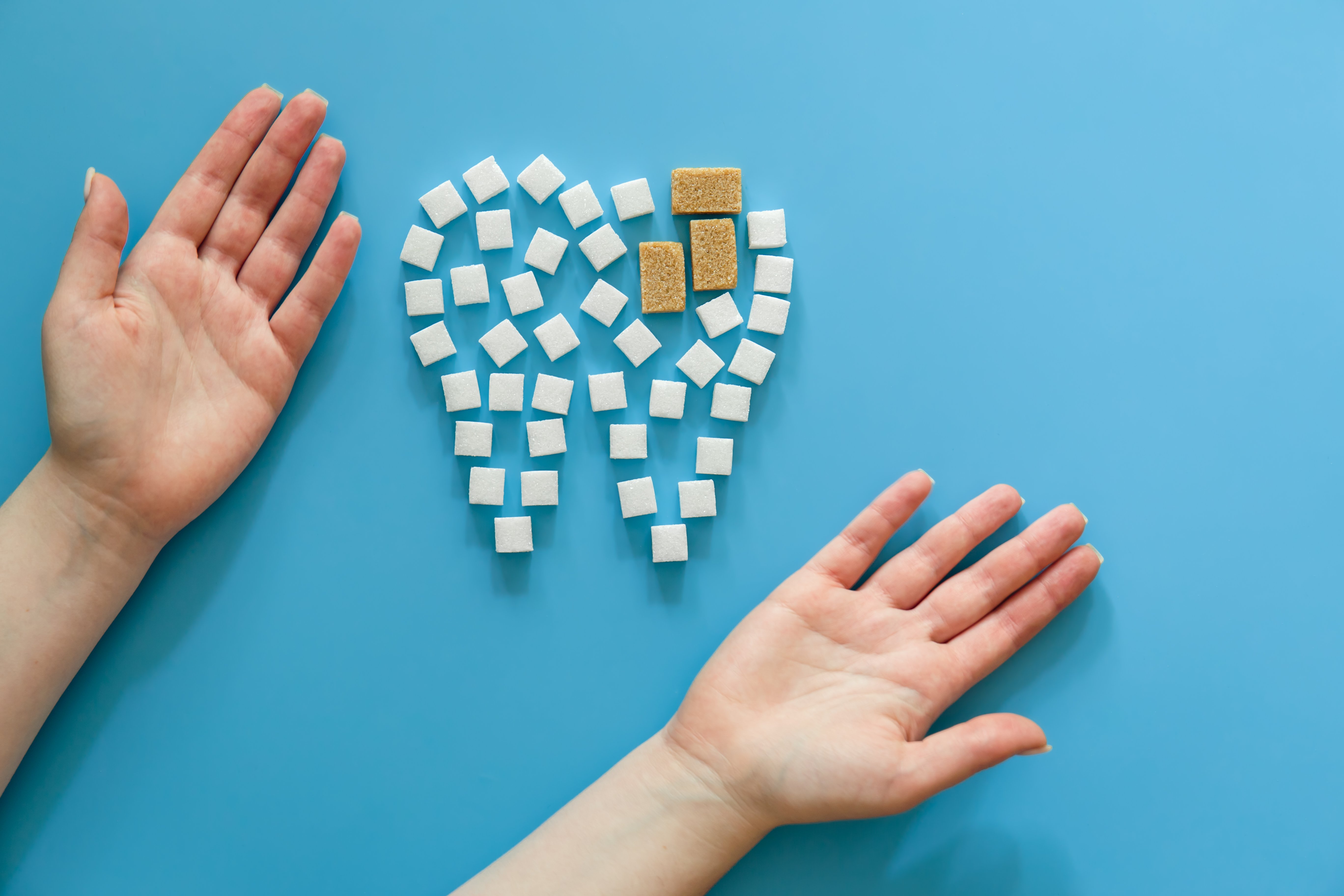 flat-lay-tooth-made-sugar-blue-background