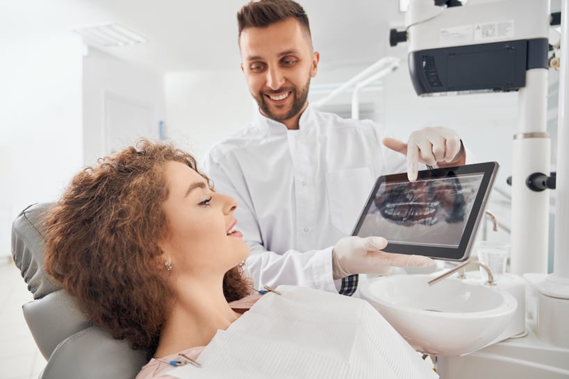 male-doctor-showing-xray-pictures-teeth-tablet