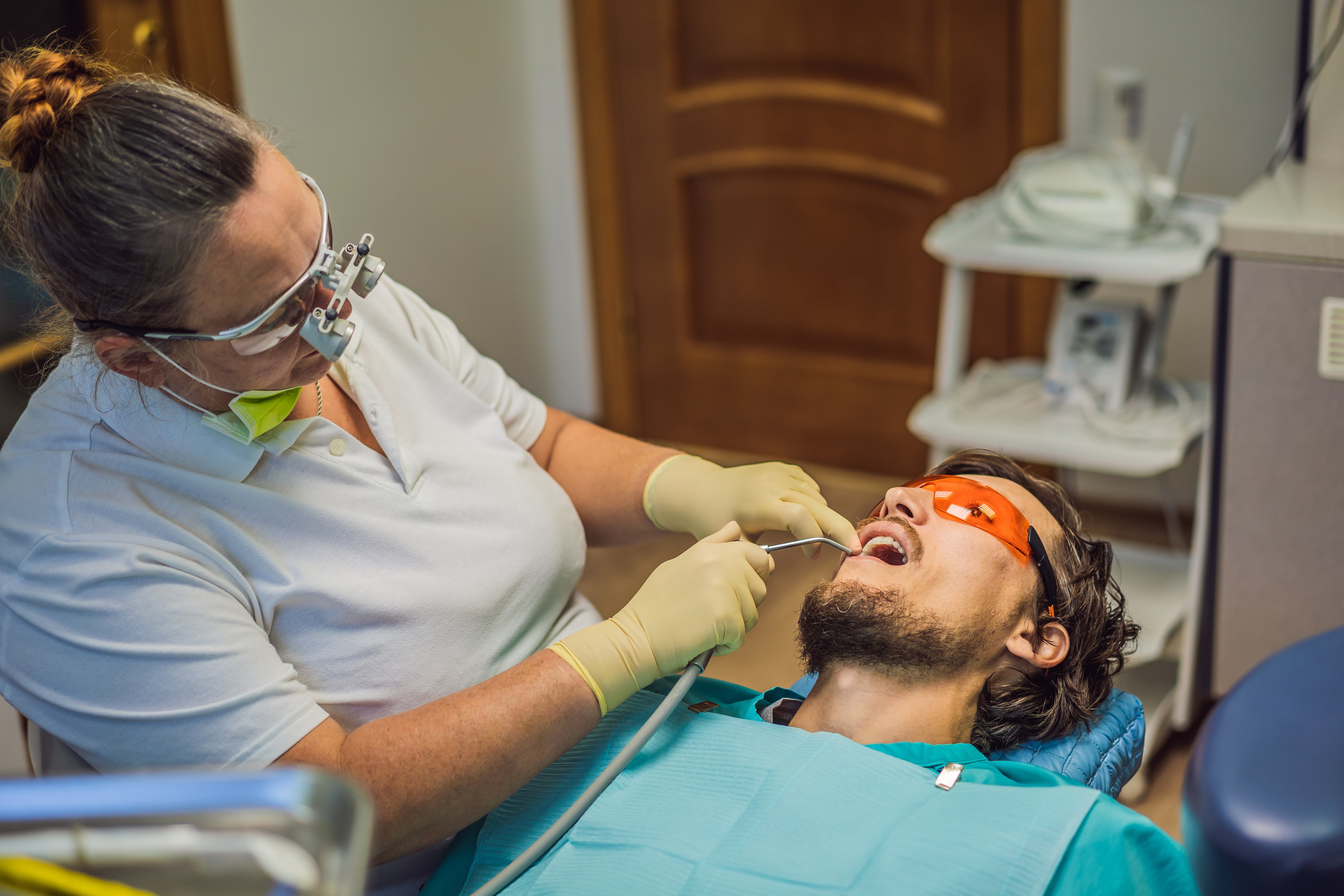 man-having-teeth-examined-dentists-dental-treatment-dentistry-appointment-dentist-lifestyle-real-life