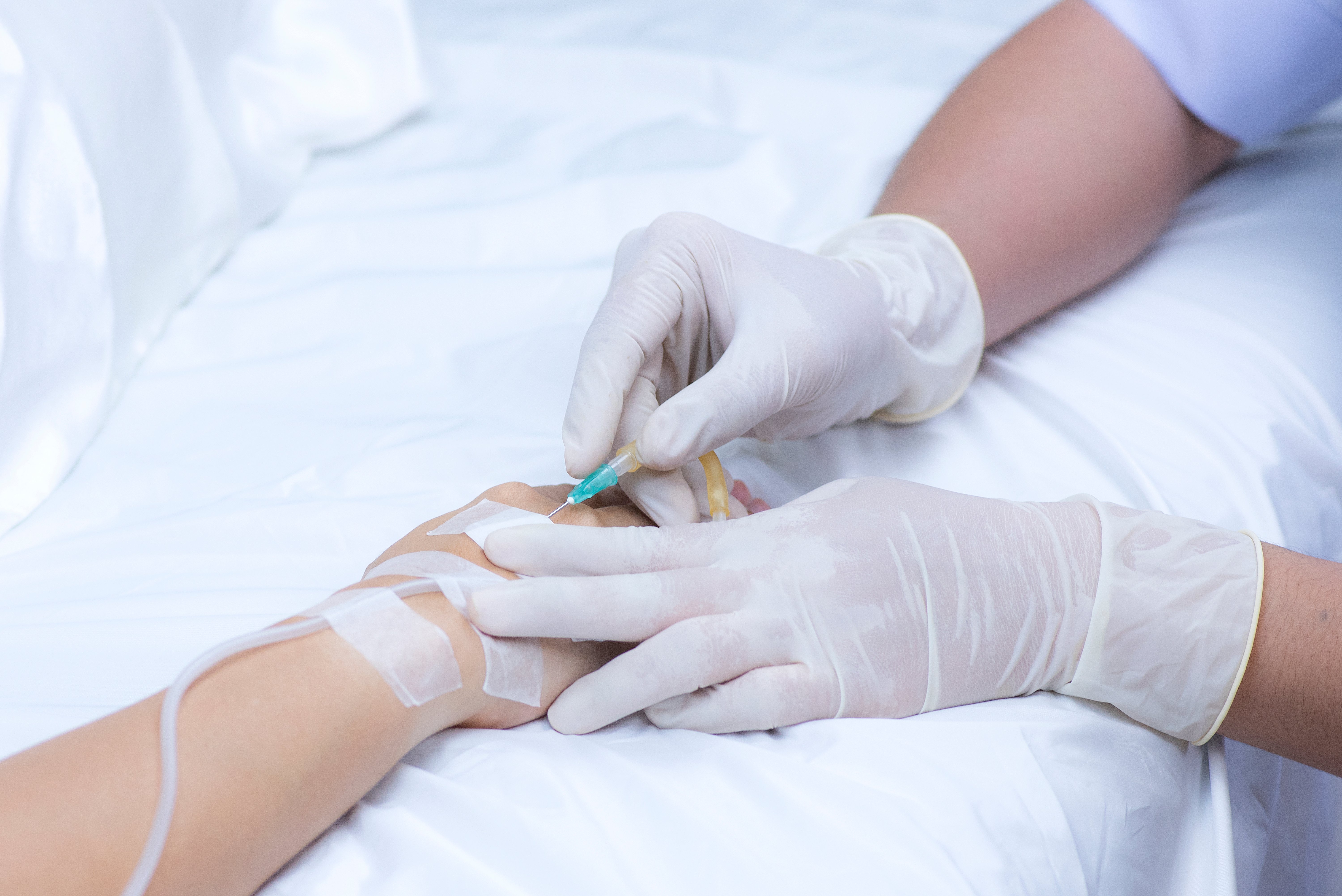 nurse-pricks-medical-needle-into-sick-patient-s-hand-prepare-saline-solution-medicine-debilitated-patient