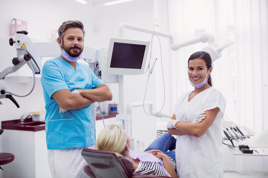 portrait-male-female-dentist-standing-dental-clinic