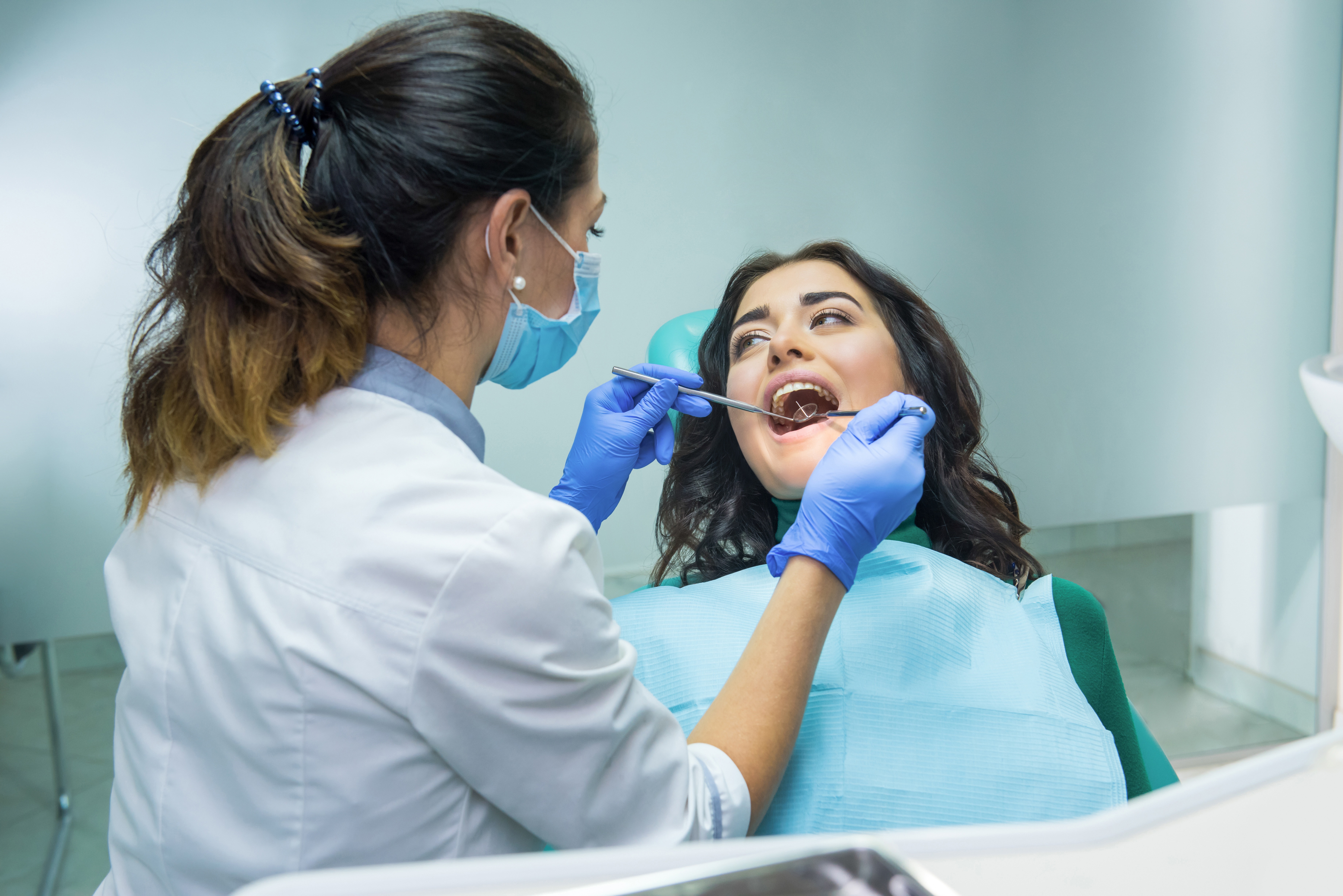 woman-dentist-stomatologist-mask-working-oral-health-assessment