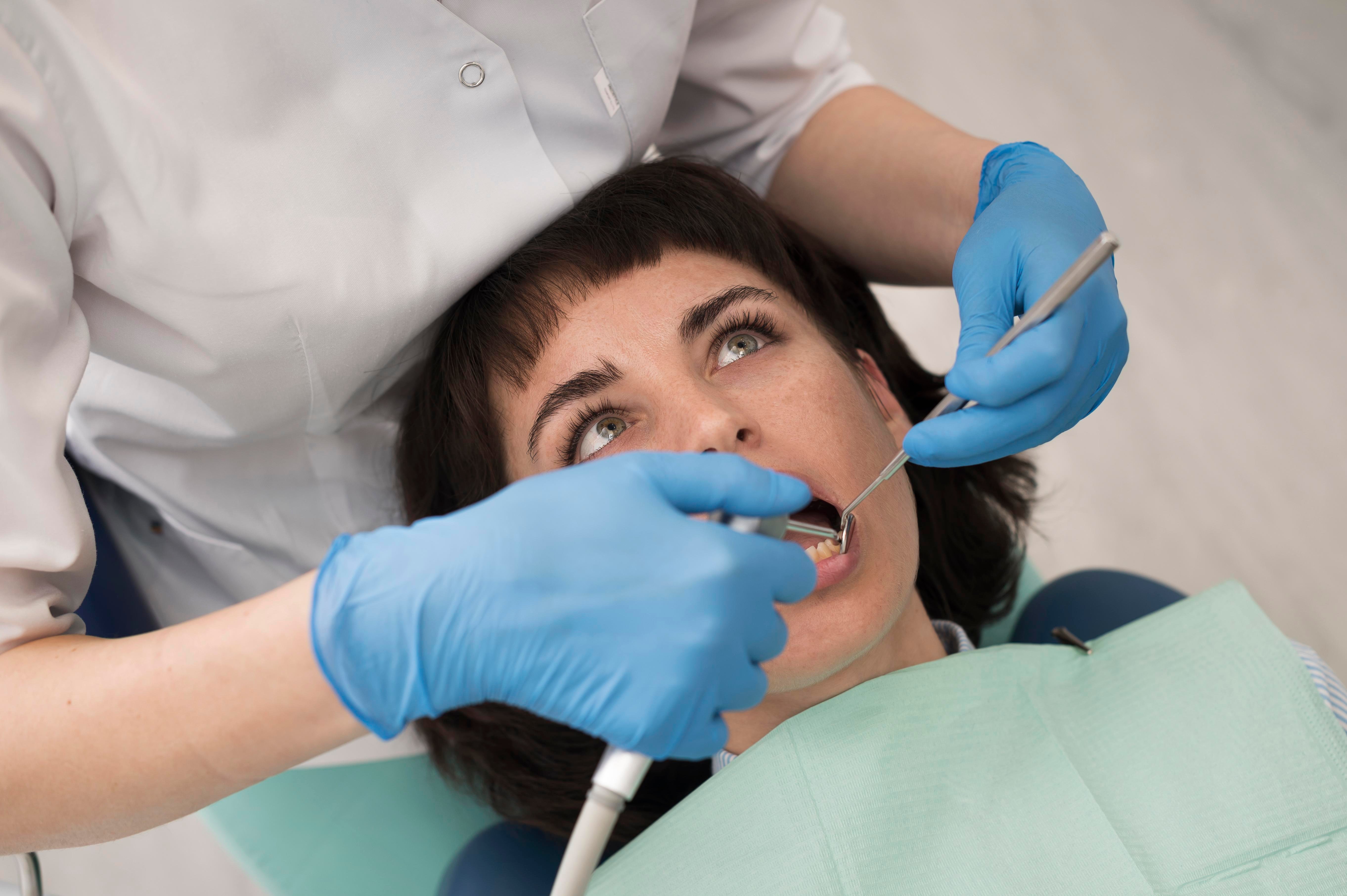 young-female-patient-having-dental-procedure-orthodontist (1)-1