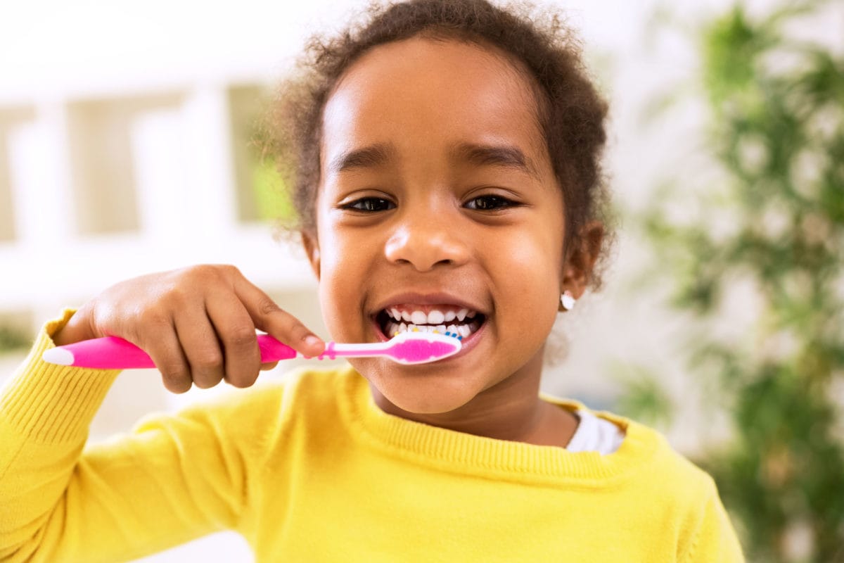 child brushing teeth